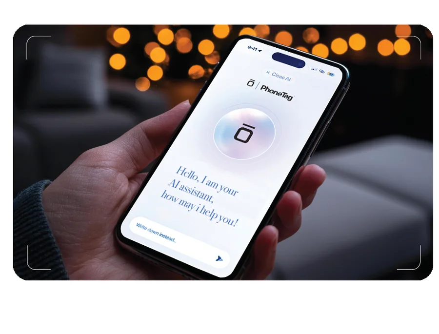 A phone showing the PhoneTag AI assistant greeting a visitor