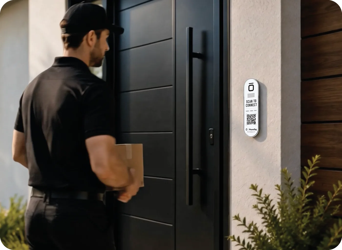 A delivery driver at a front door beside a PhoneTag Doorbell tag