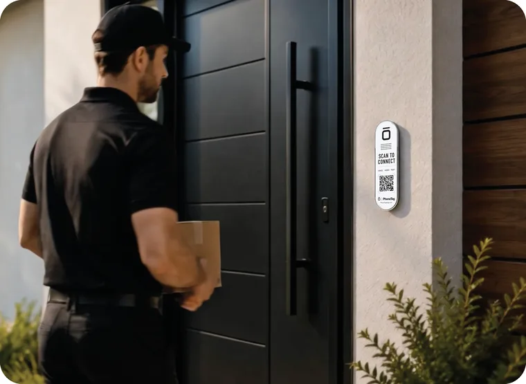 A delivery driver standing at a front door with a PhoneTag Doorbell tag